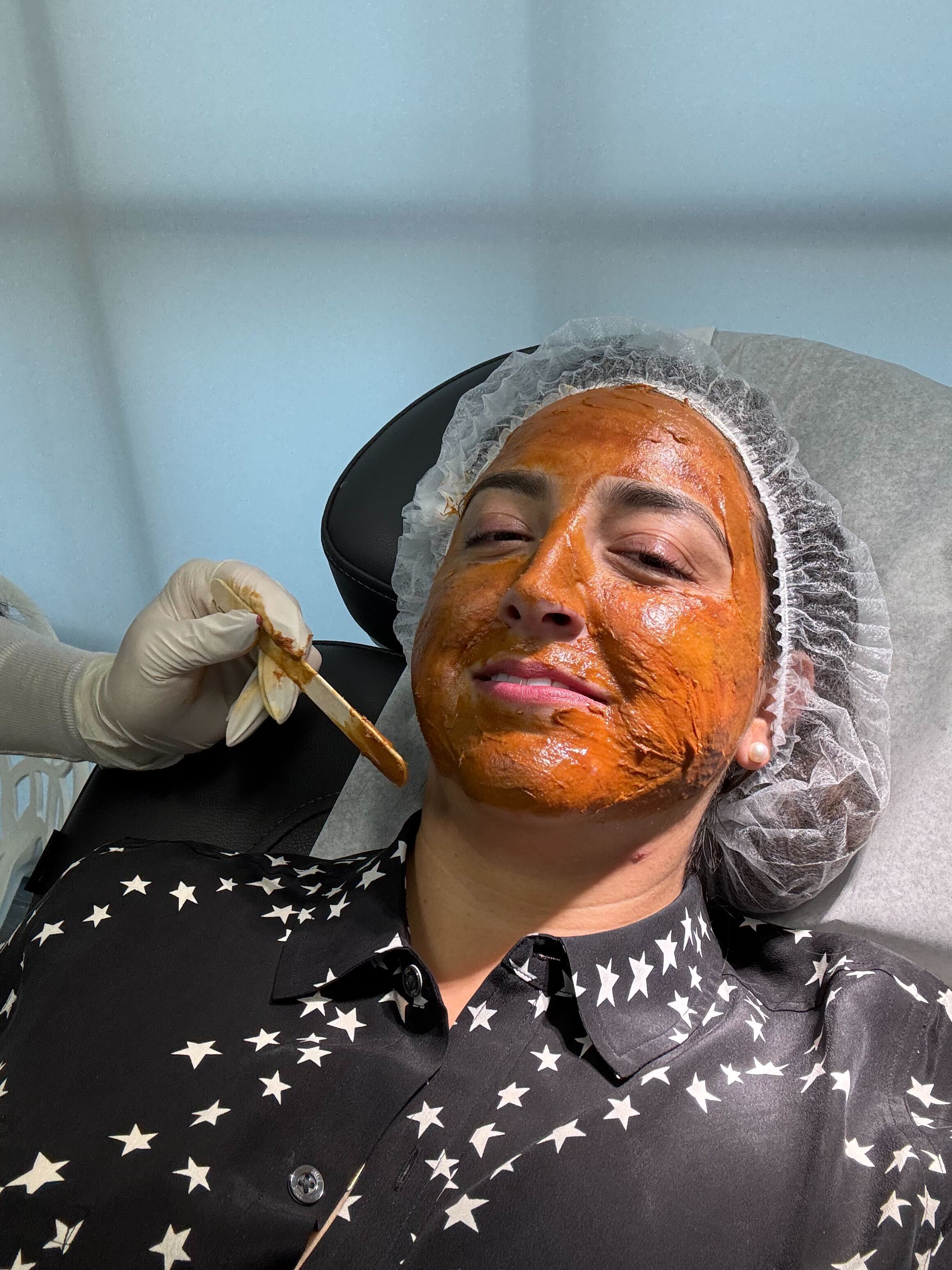 A client receiving an in-clinic treatment mask